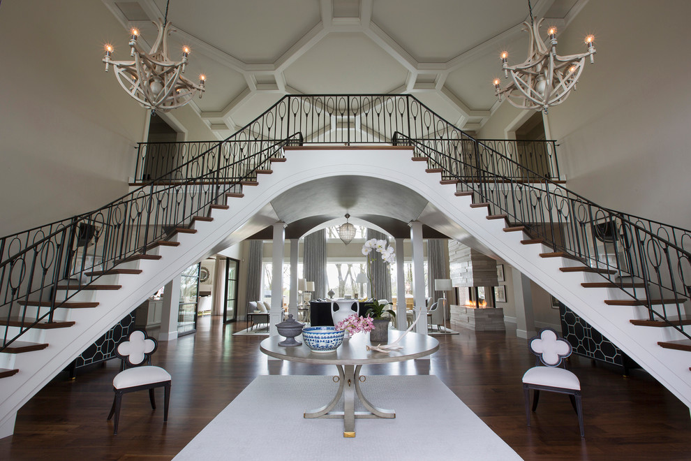 Example of a huge transitional medium tone wood floor foyer design with gray walls and a dark wood front door