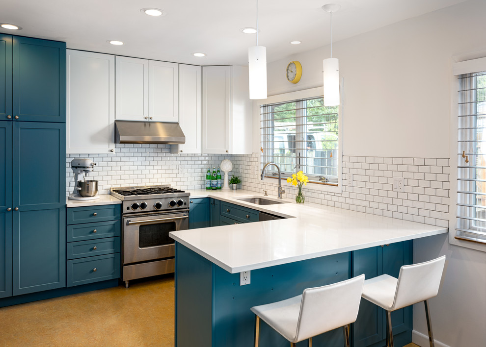 Inspiration for a mid-sized midcentury u-shaped eat-in kitchen in Portland with an undermount sink, shaker cabinets, blue cabinets, quartzite benchtops, white splashback, subway tile splashback, stainless steel appliances, linoleum floors, a peninsula and orange floor.