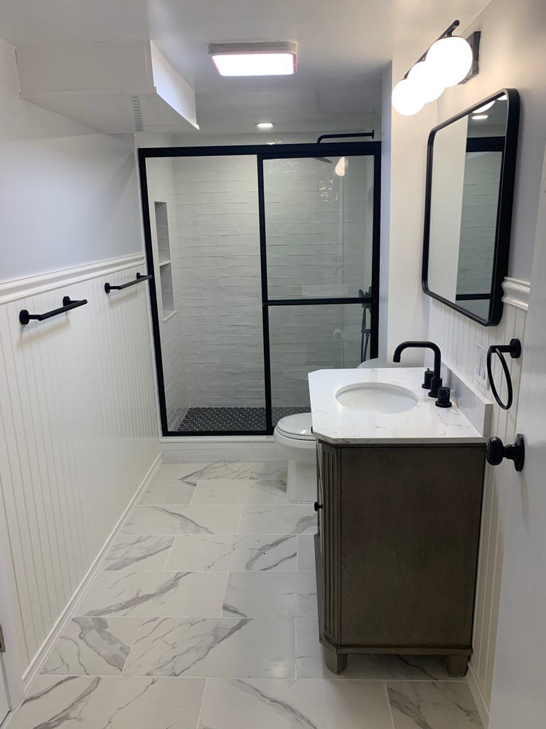 Doorless shower - mid-sized transitional 3/4 white tile and porcelain tile porcelain tile, white floor and single-sink doorless shower idea in Boston with furniture-like cabinets, brown cabinets, a tw