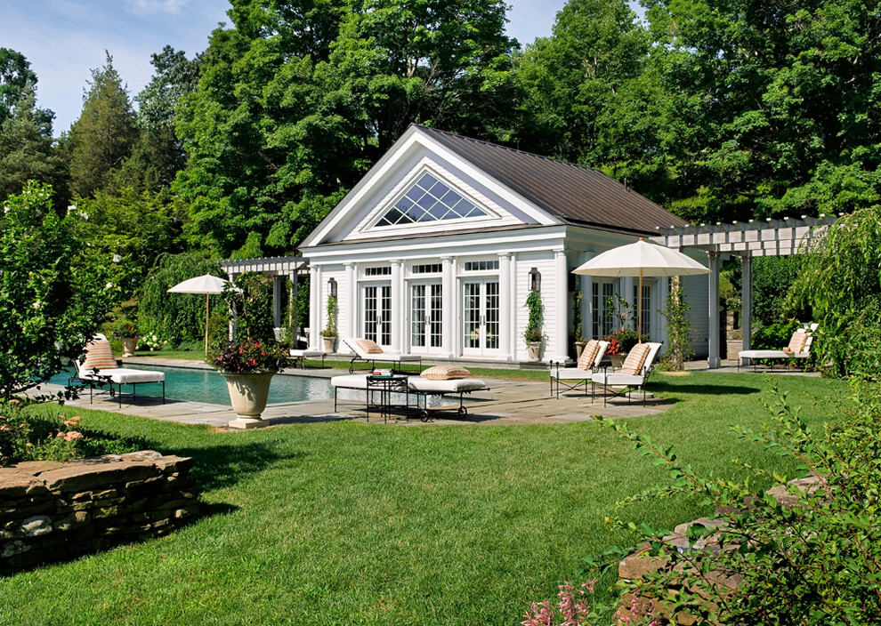 Traditional pool in New York with a pool house.