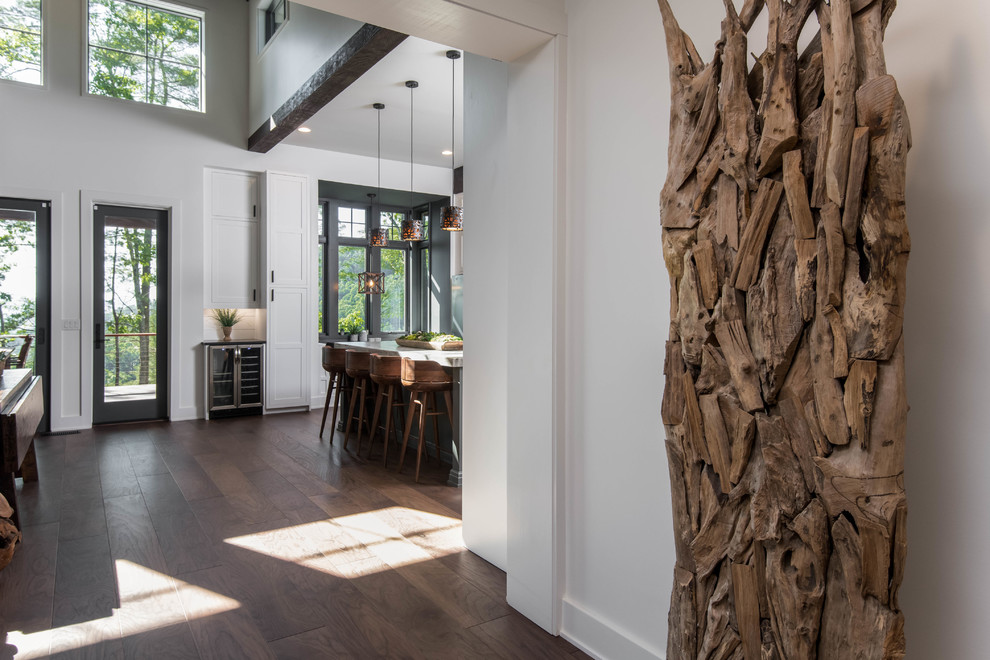 Inspiration for a mid-sized rustic medium tone wood floor and beige floor hallway remodel in Other with white walls