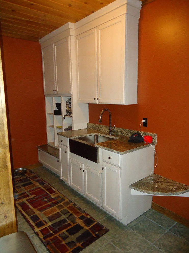 Photo of a small country mudroom in Boston with orange walls and ceramic floors.