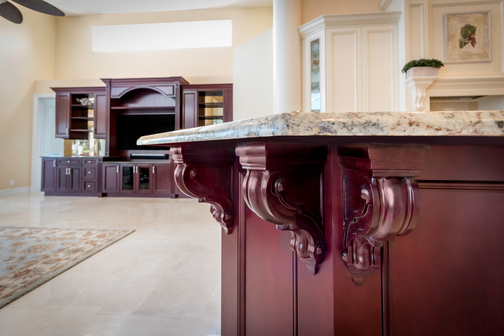 Example of a large transitional u-shaped marble floor kitchen design in Miami with shaker cabinets, granite countertops and an island