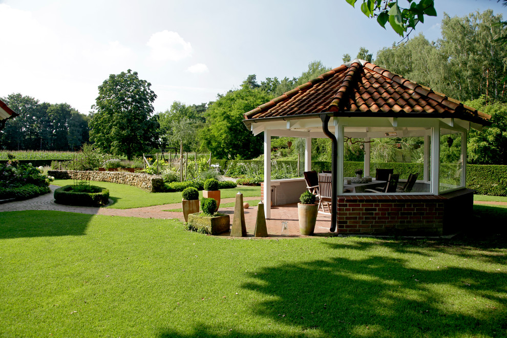 Photo of an expansive country backyard partial sun garden for summer in Other with a vegetable garden and brick pavers.