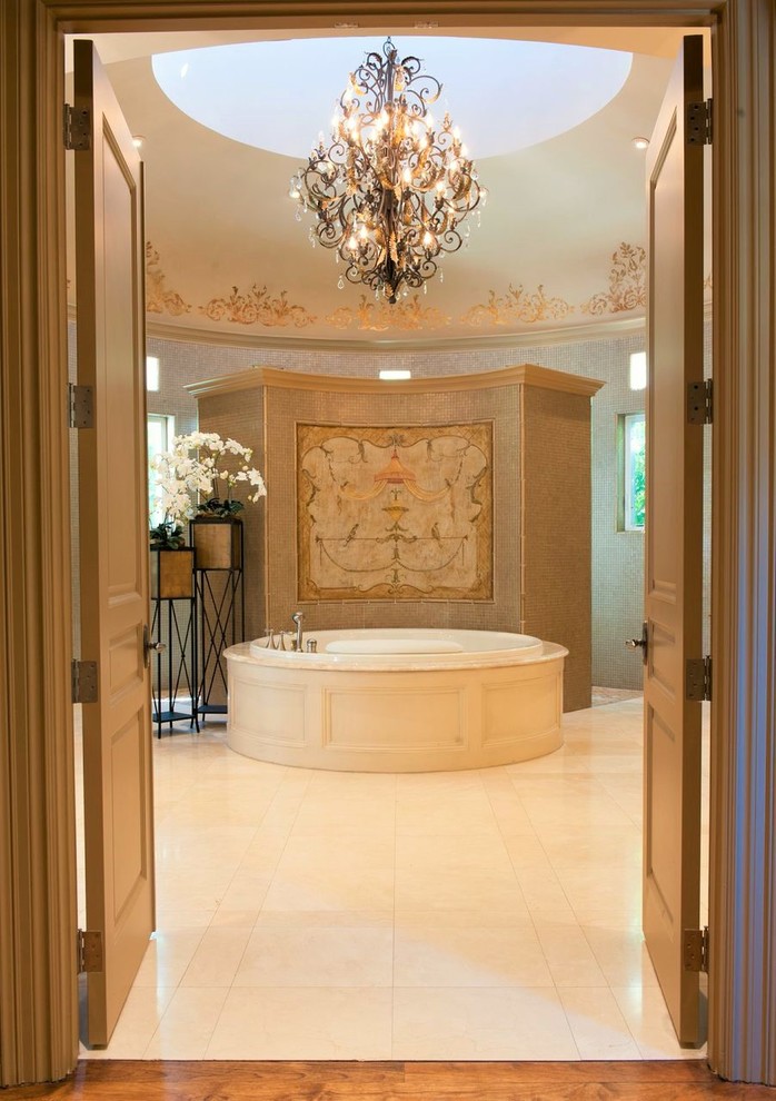 Inspiration for a large traditional master bathroom in Austin with raised-panel cabinets, white cabinets, a hot tub, beige walls, marble floors, granite benchtops, beige floor and a drop-in sink.