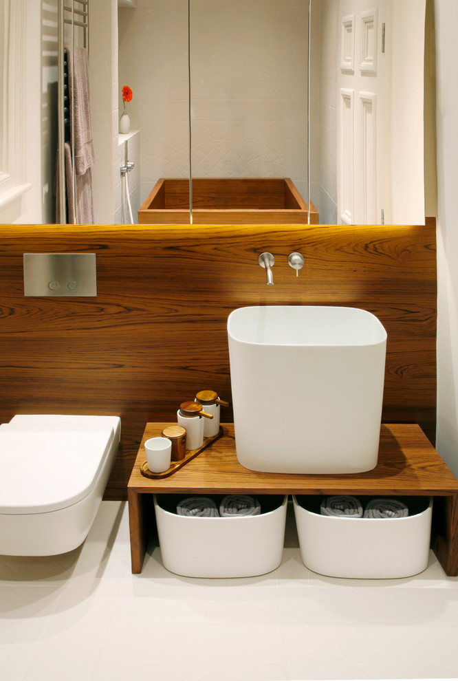Photo of a contemporary bathroom in London with a vessel sink and a wall-mount toilet.