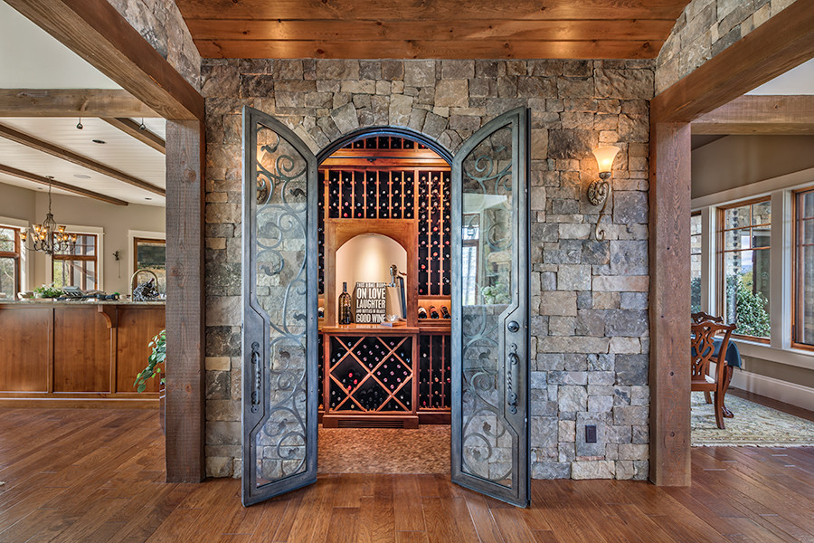 Photo of a country wine cellar in Other with cork floors.