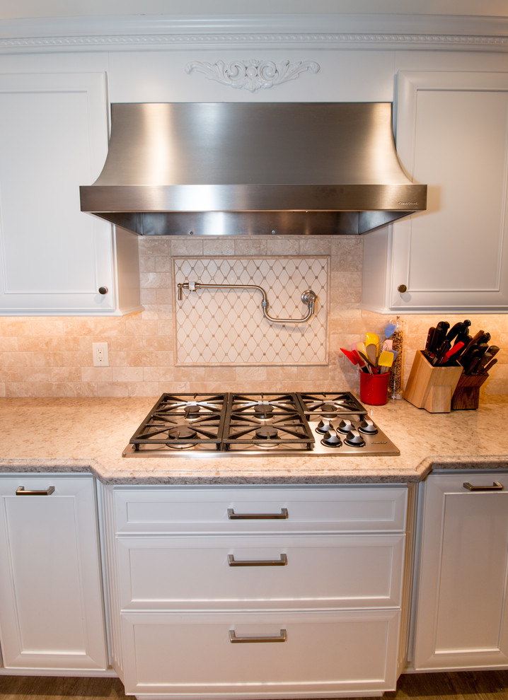 Inspiration for a huge transitional open concept kitchen remodel with a farmhouse sink, recessed-panel cabinets, white cabinets, quartz countertops, beige backsplash, stone tile backsplash, stainless steel appliances and an island