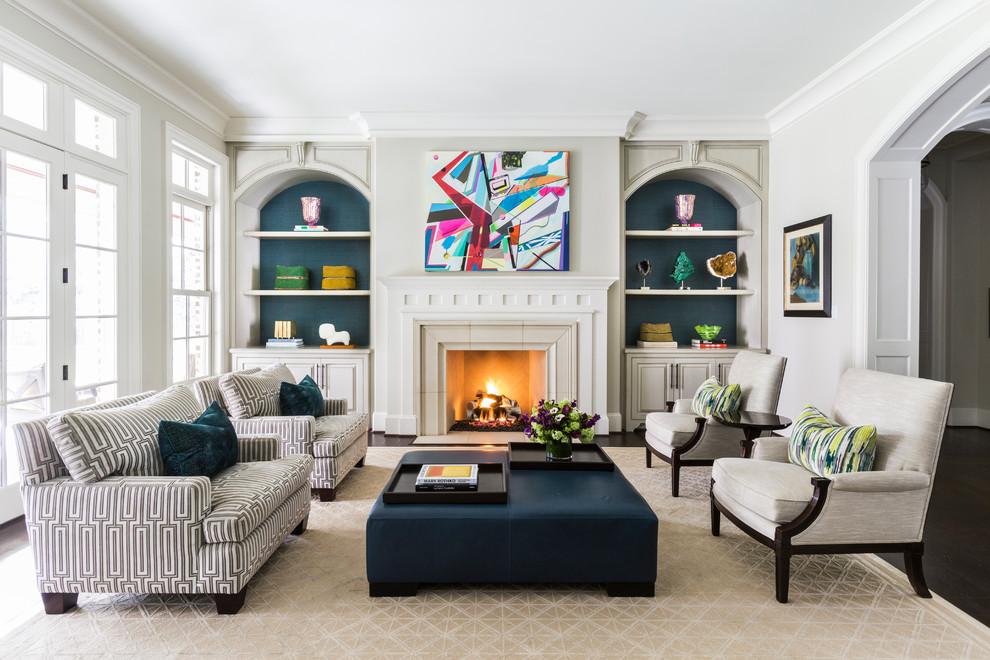 Example of a transitional beige floor living room design in Houston with beige walls and a standard fireplace
