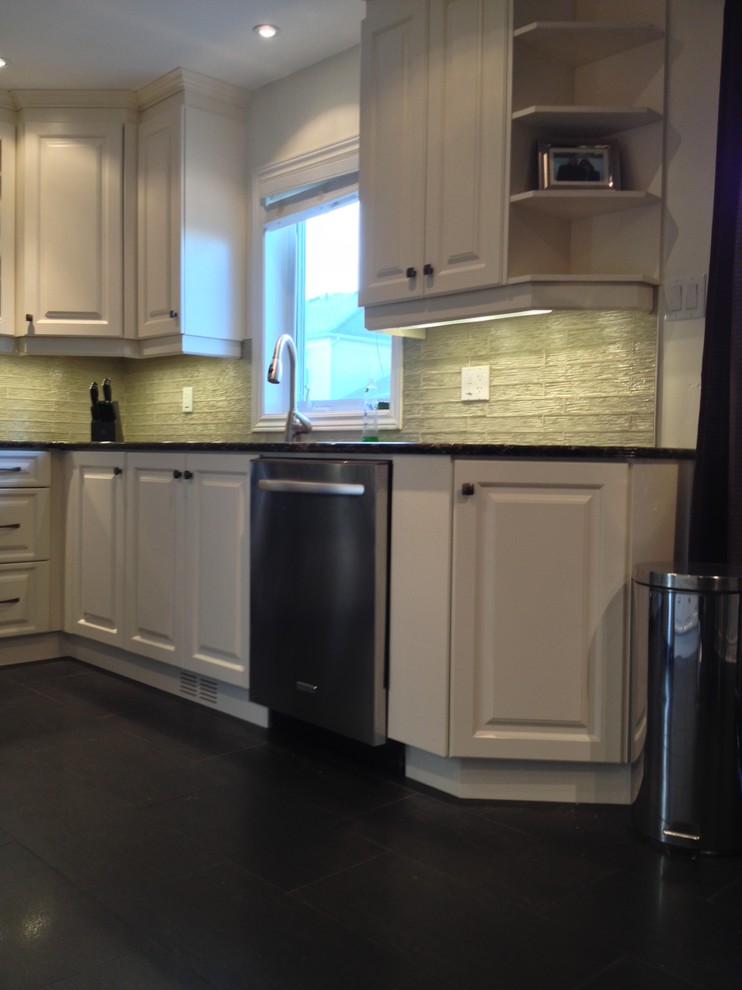 Inspiration for a mid-sized transitional l-shaped porcelain tile enclosed kitchen remodel in Ottawa with an undermount sink, raised-panel cabinets, white cabinets, quartz countertops, beige backsplash, glass tile backsplash, stainless steel appliances and no island