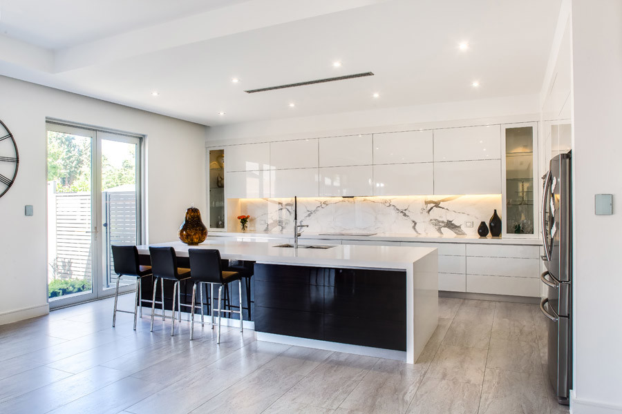 Design ideas for a large modern eat-in kitchen in Adelaide with with island, white splashback, stone slab splashback, a drop-in sink, white appliances and porcelain floors.