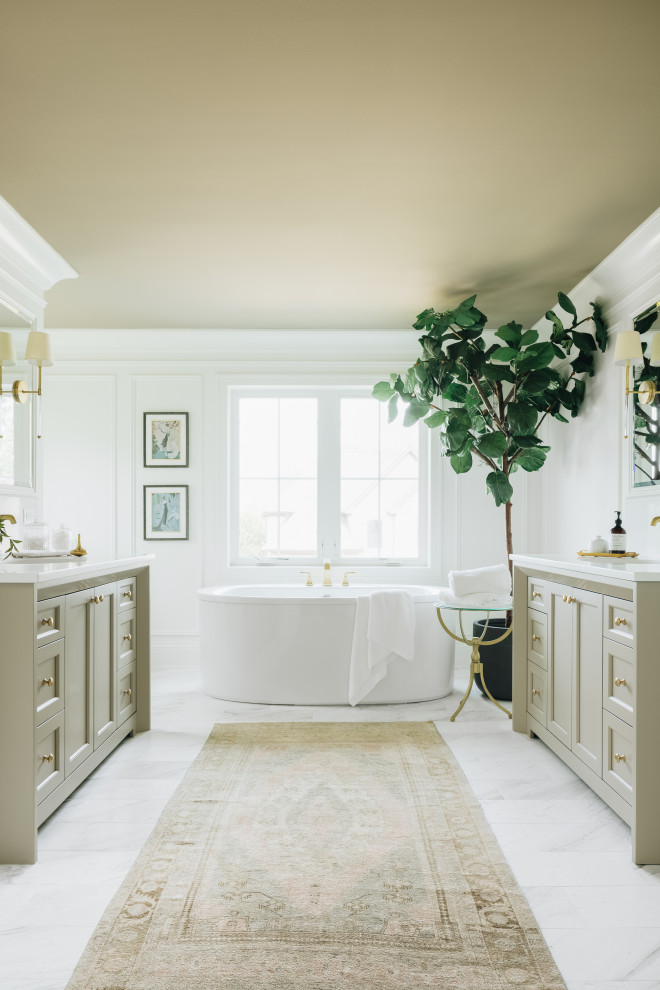 Example of a transitional master white floor and double-sink freestanding bathtub design in Chicago with recessed-panel cabinets, beige cabinets, white walls, an undermount sink, white countertops and a built-in vanity