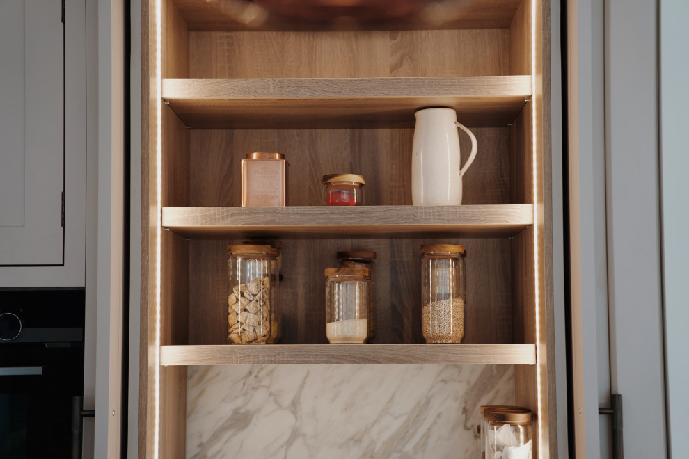 This is an example of a medium sized classic l-shaped kitchen in London with a submerged sink, shaker cabinets, pink cabinets, quartz worktops, white splashback, an island and white worktops.