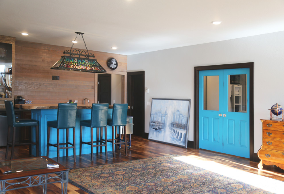 Inspiration for a large transitional galley medium tone wood floor home design remodel with an undermount sink, raised-panel cabinets, blue cabinets, wood countertops and brown backsplash