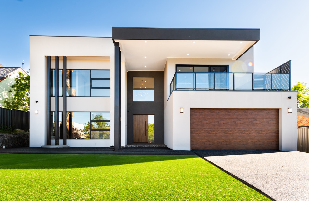 Design ideas for a large contemporary two-storey house exterior in Canberra - Queanbeyan with a flat roof and a metal roof.
