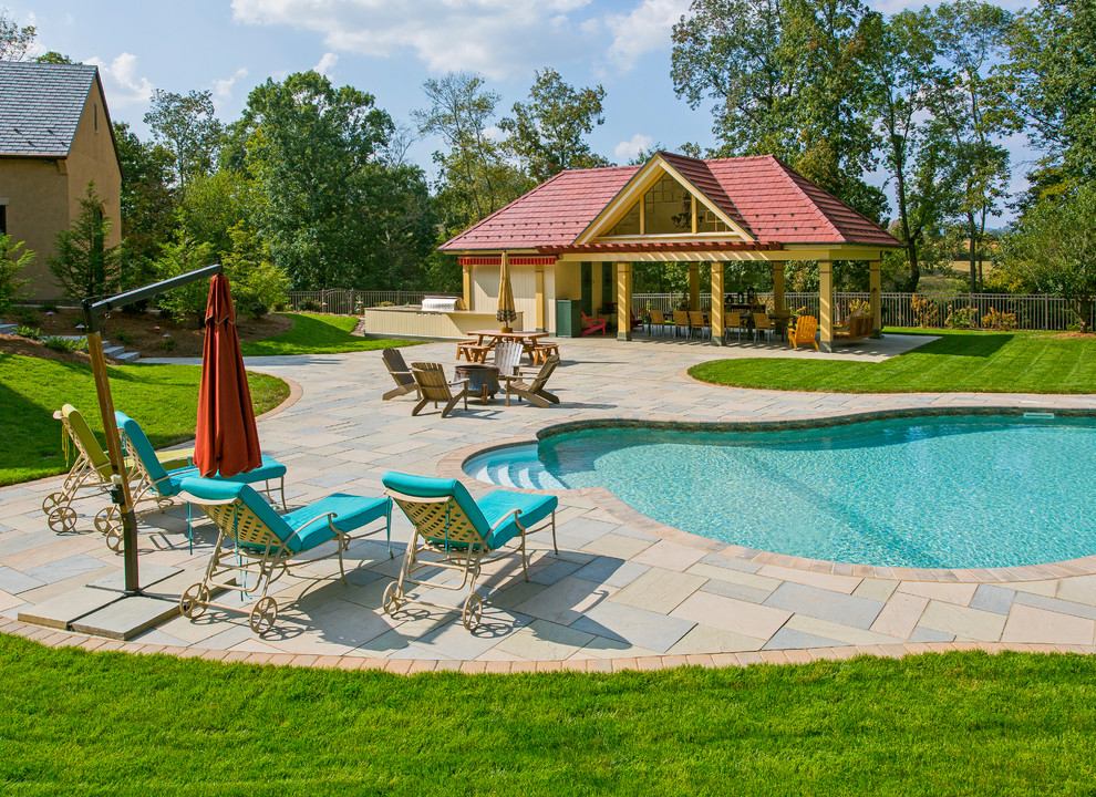 Mid-sized transitional backyard tile and kidney-shaped pool house photo