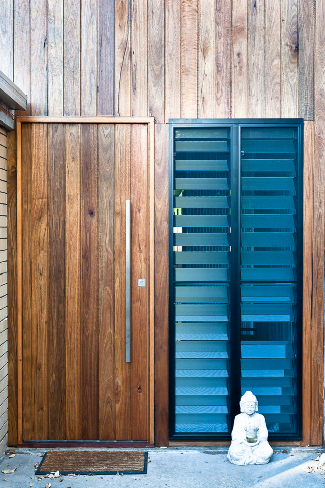 Photo of a mid-sized industrial front door in Gold Coast - Tweed with concrete floors.