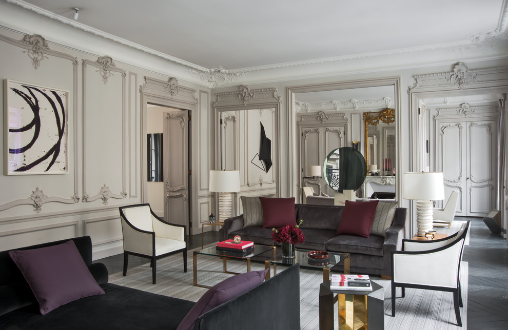 Expansive eclectic formal enclosed living room in Paris with beige walls, dark hardwood floors, no fireplace and no tv.