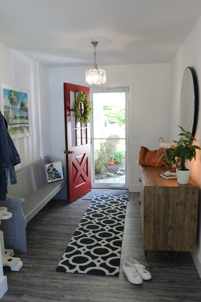 This is an example of a mid-sized beach style front door in Other with white walls, porcelain floors, a single front door, a red front door and grey floor.