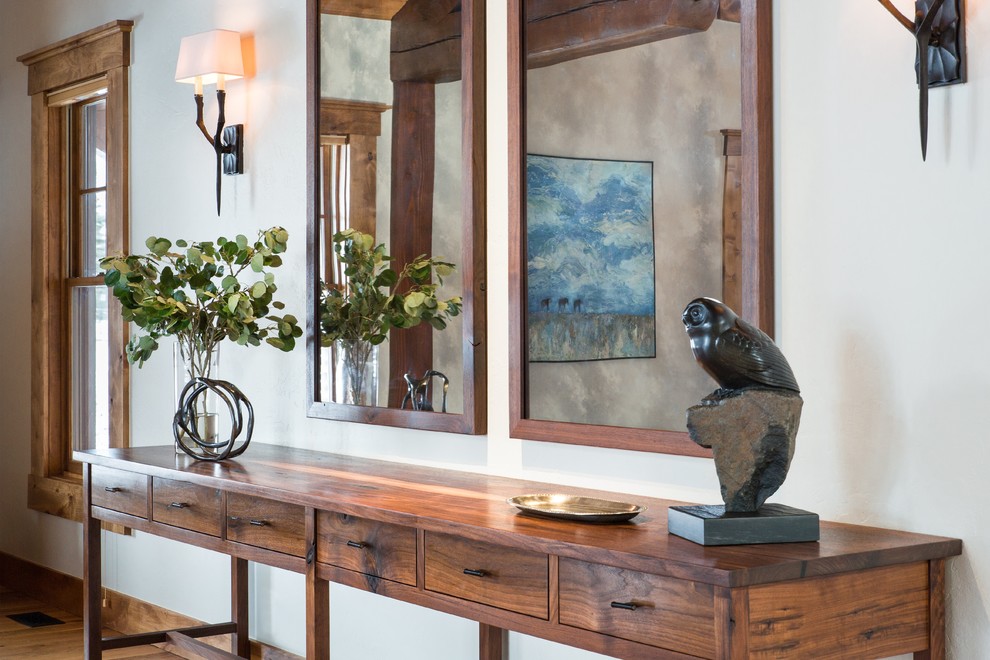 Foyer - large transitional light wood floor foyer idea with white walls