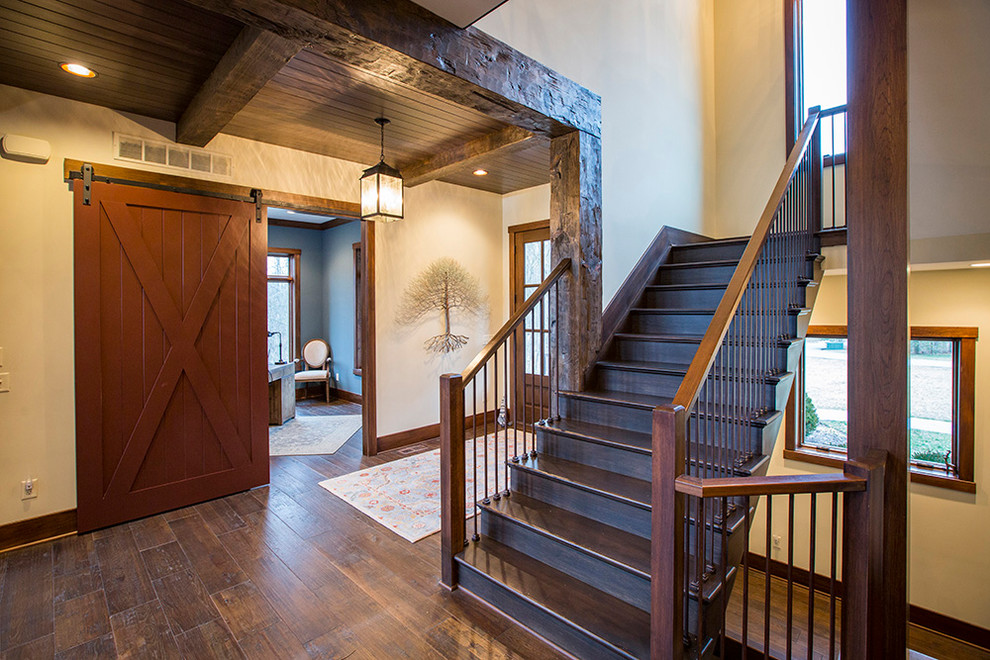 Large eclectic wood u-shaped staircase in Cincinnati with wood risers and mixed railing.