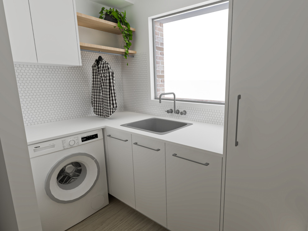 Photo of a small scandinavian l-shaped dedicated laundry room in Other with white cabinets, quartz benchtops and white benchtop.