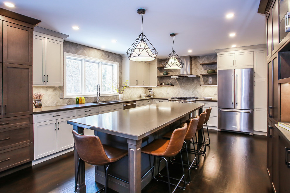 Inspiration for a large transitional l-shaped dark wood floor and brown floor eat-in kitchen remodel in Toronto with an undermount sink, shaker cabinets, gray cabinets, quartz countertops, gray backsplash, porcelain backsplash, stainless steel appliances and an island