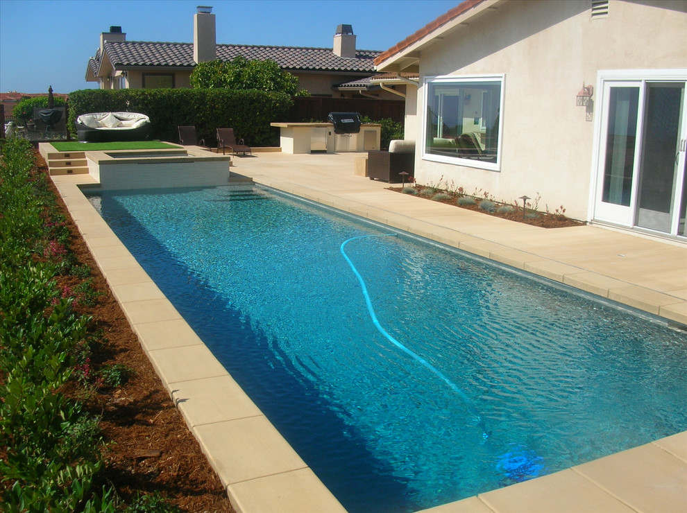 Inspiration for a large backyard concrete paver and rectangular natural hot tub remodel in San Diego