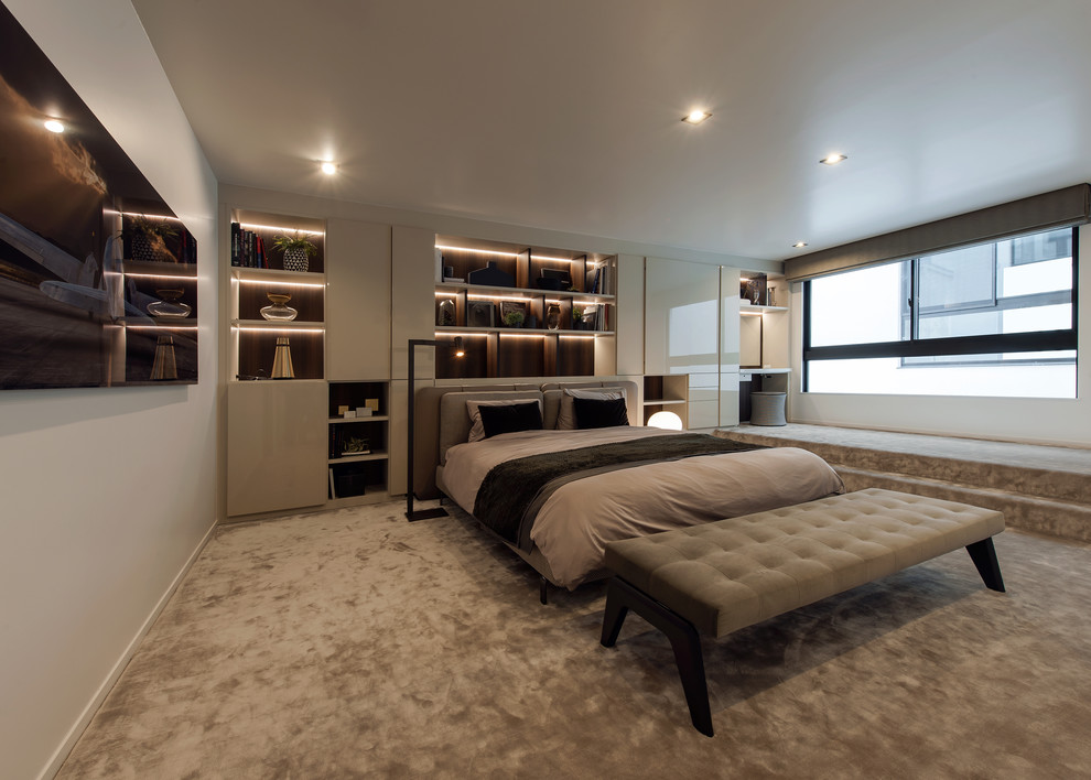 Contemporary bedroom with white walls, carpet and grey floor.