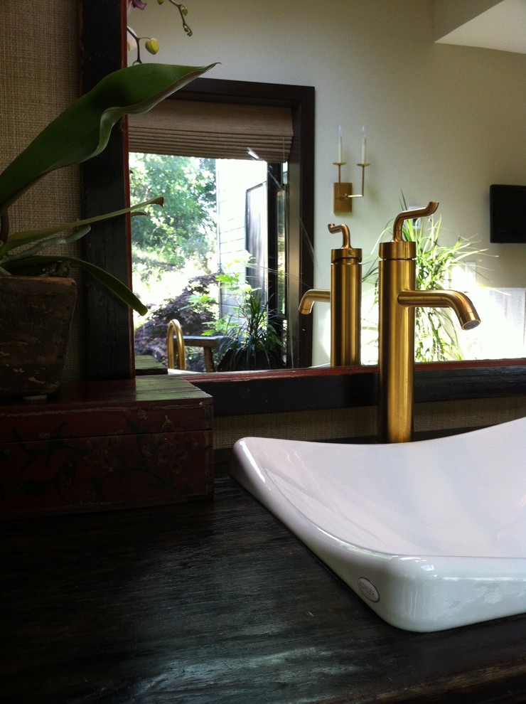Inspiration for an asian master bathroom in Other with dark wood cabinets and a freestanding tub.