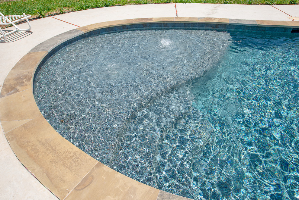 Inspiration for a mid-sized rustic backyard stone and custom-shaped natural hot tub remodel