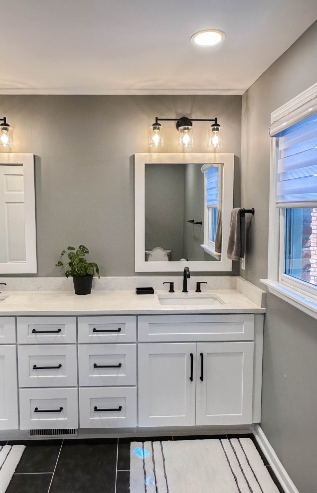 Example of a mid-sized transitional master porcelain tile, black floor and double-sink bathroom design with shaker cabinets, white cabinets, a two-piece toilet, gray walls, an undermount sink, quartz countertops, white countertops and a built-in vanity