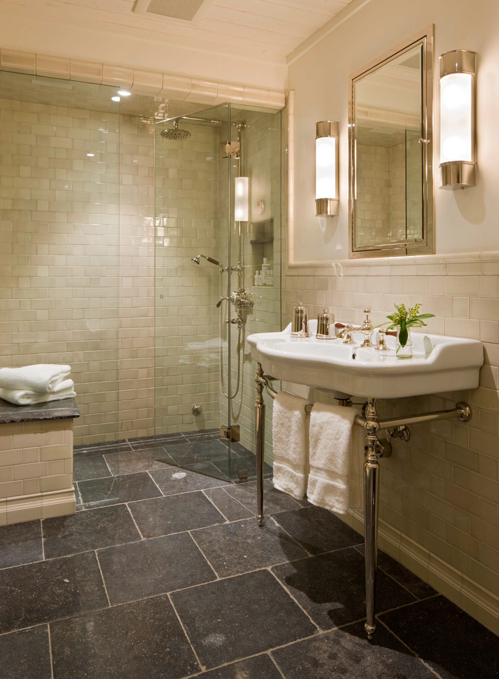 Traditional bathroom in Denver with a console sink, an alcove shower, beige tile, subway tile and black floor.