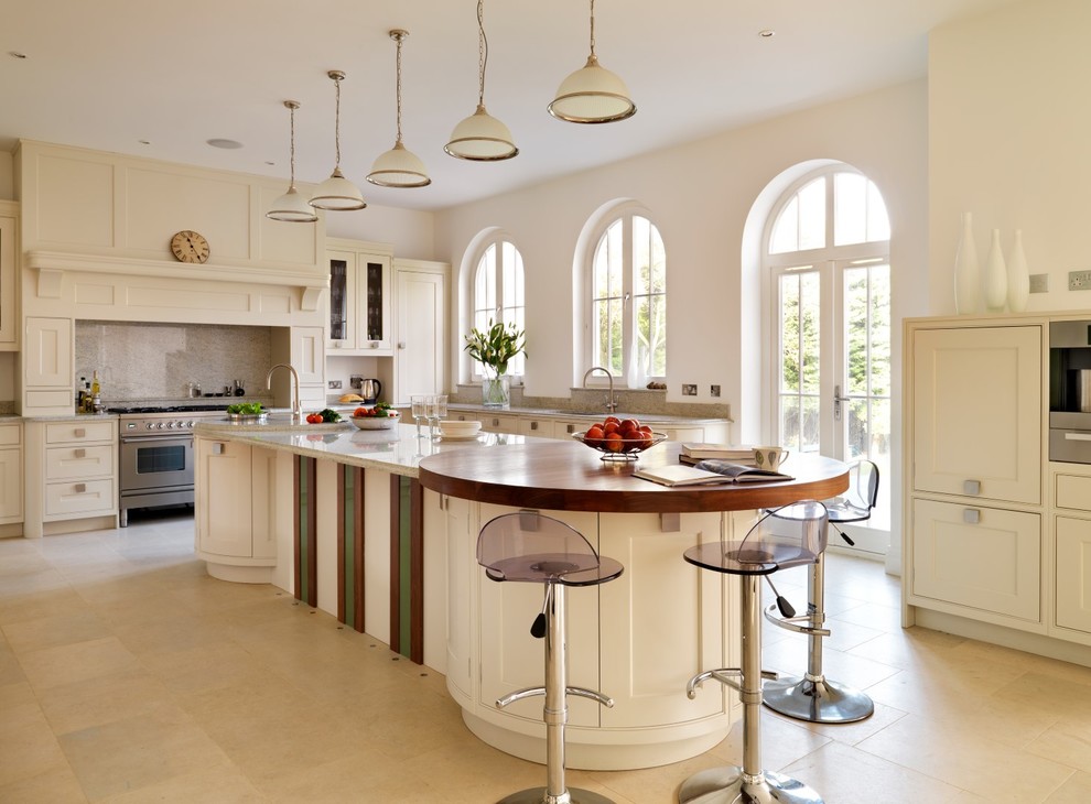 Photo of a transitional l-shaped eat-in kitchen in Berkshire with shaker cabinets, white cabinets, stainless steel appliances and with island.