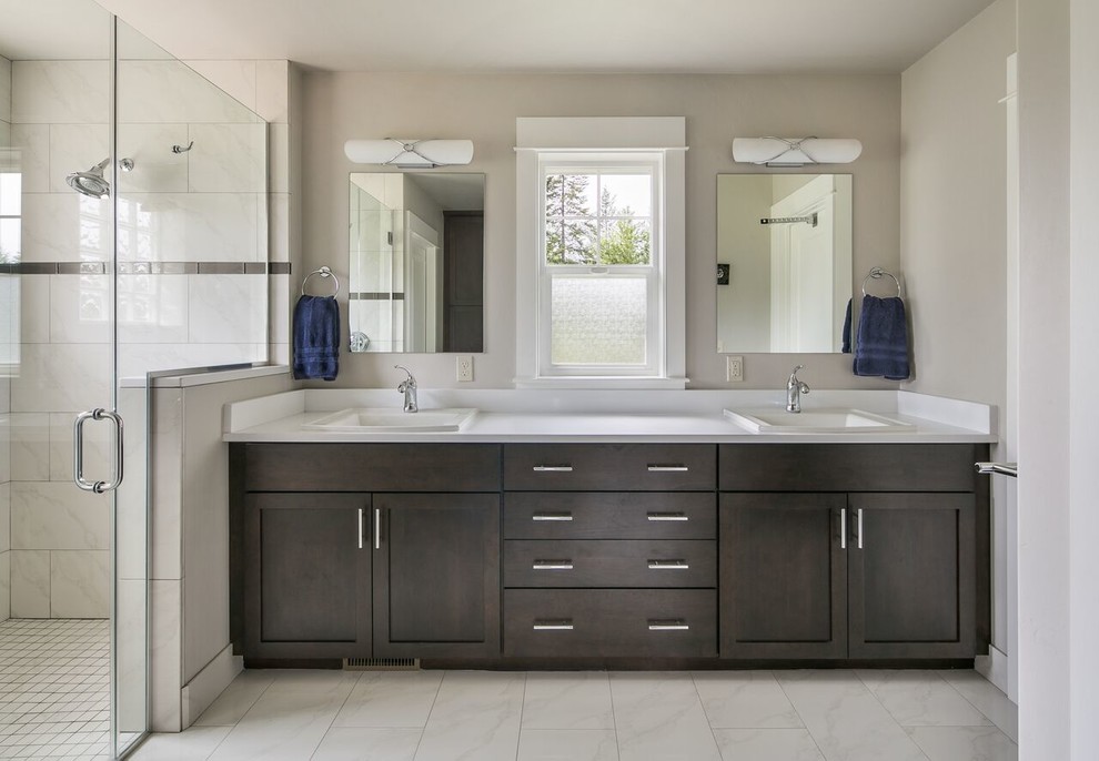 Inspiration for a mid-sized transitional master bathroom in Other with shaker cabinets, dark wood cabinets, a curbless shower, a two-piece toilet, white tile, porcelain tile, grey walls, porcelain floors, a drop-in sink, engineered quartz benchtops, white floor and a hinged shower door.