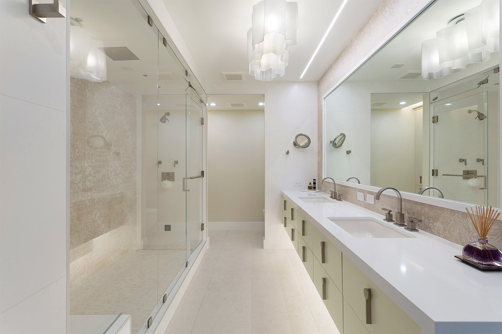 Inspiration for a mid-sized contemporary master bathroom in Miami with flat-panel cabinets, beige cabinets, an alcove shower, beige tile, an undermount sink, beige floor, white benchtops, a one-piece toilet, porcelain tile, beige walls, porcelain floors, solid surface benchtops and a hinged shower door.