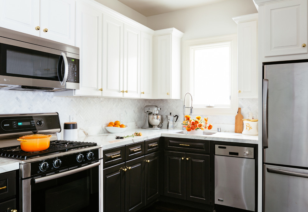 Photo of a small transitional l-shaped eat-in kitchen in San Francisco with an undermount sink, raised-panel cabinets, white cabinets, marble benchtops, white splashback, stone tile splashback, stainless steel appliances, dark hardwood floors and no island.