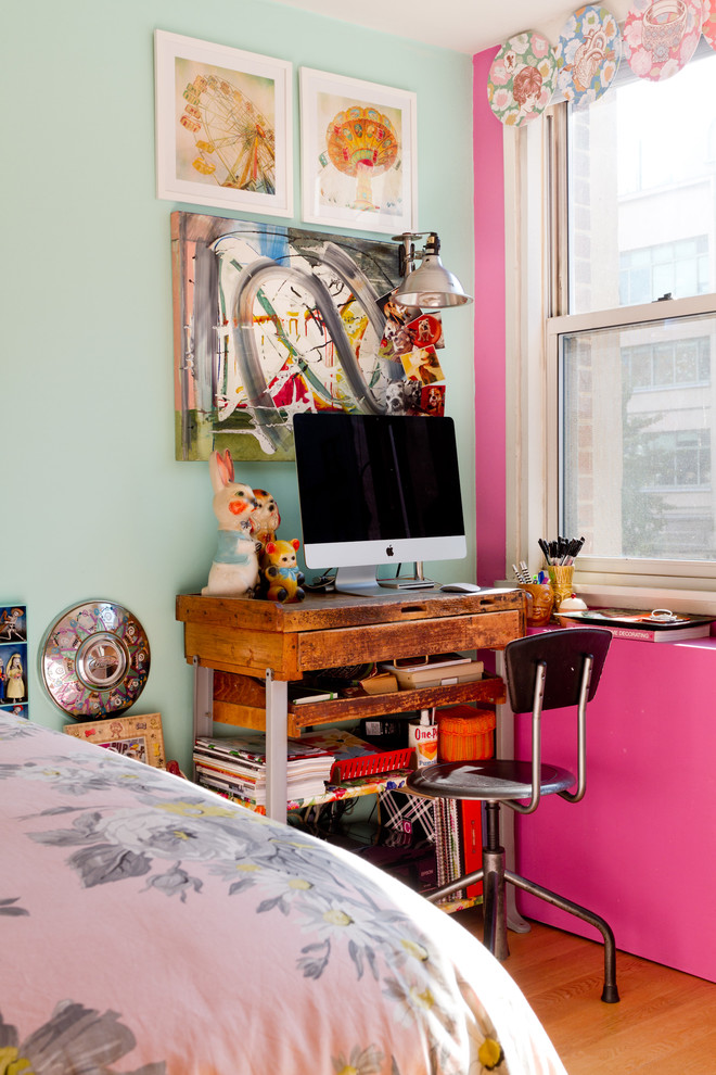 Inspiration for an eclectic bedroom in New York with blue walls and medium hardwood floors.