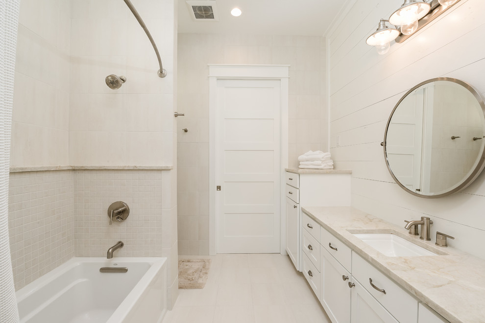 Inspiration for a mid-sized country bathroom in Dallas with shaker cabinets, white cabinets, an alcove tub, a shower/bathtub combo, white tile, porcelain tile, white walls, porcelain floors, an undermount sink, granite benchtops, white floor, a shower curtain and white benchtops.