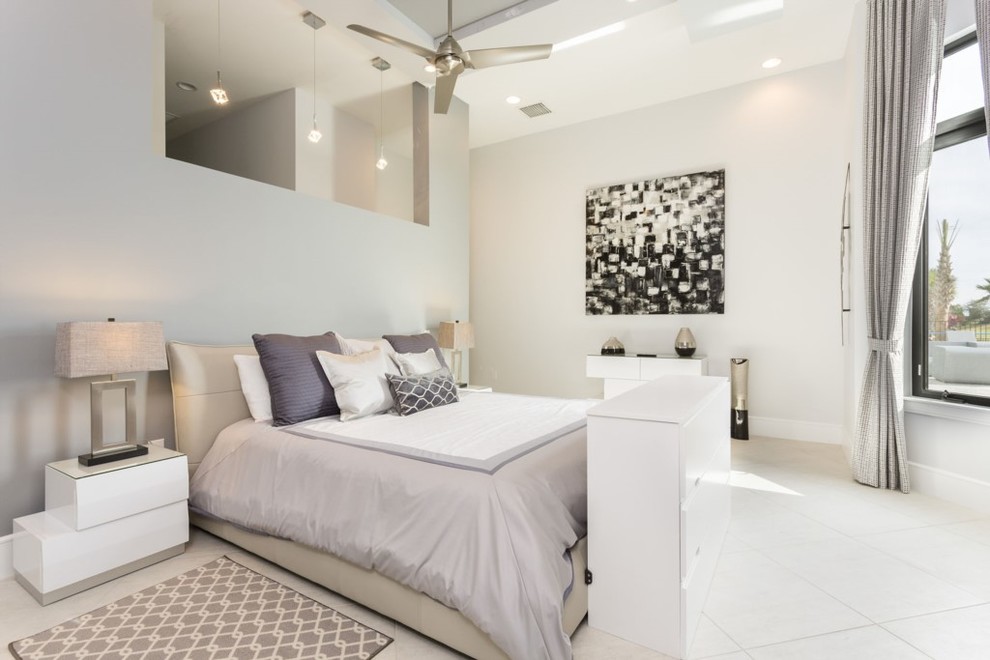 Photo of a large transitional master bedroom in Orlando with white walls, porcelain floors and no fireplace.