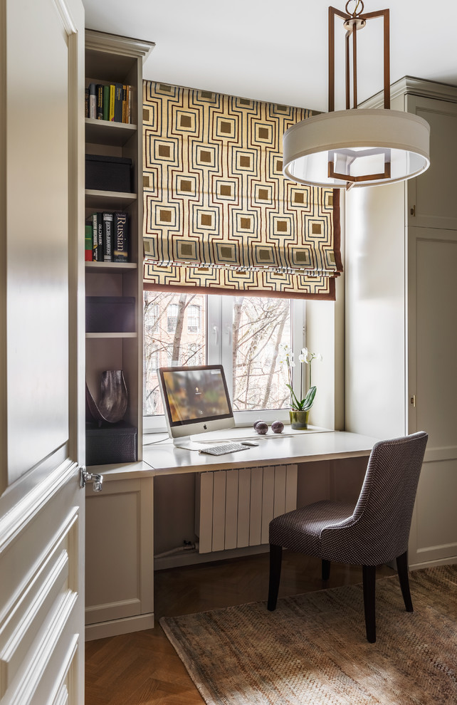 Photo of a small transitional study room in Other with grey walls, medium hardwood floors and a built-in desk.