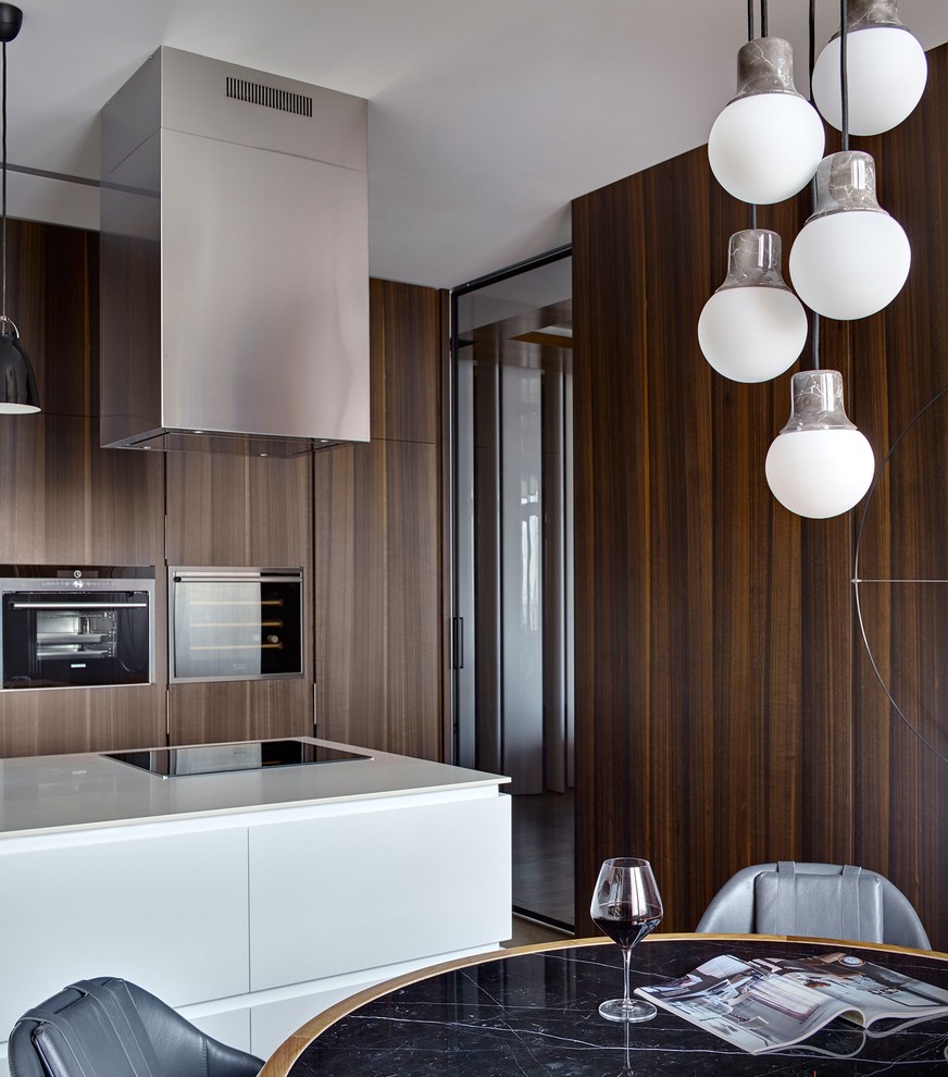 Inspiration for a contemporary galley eat-in kitchen in Moscow with flat-panel cabinets, black appliances and with island.