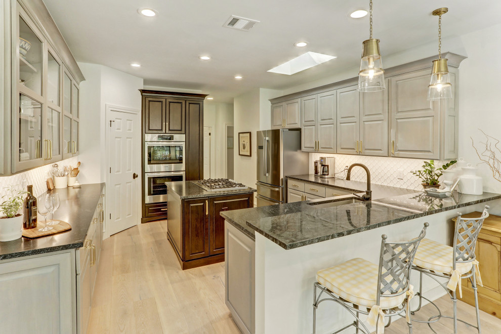 Mid-sized transitional u-shaped separate kitchen in Austin with a single-bowl sink, recessed-panel cabinets, grey cabinets, quartzite benchtops, white splashback, porcelain splashback, stainless steel appliances, light hardwood floors, with island, beige floor and green benchtop.
