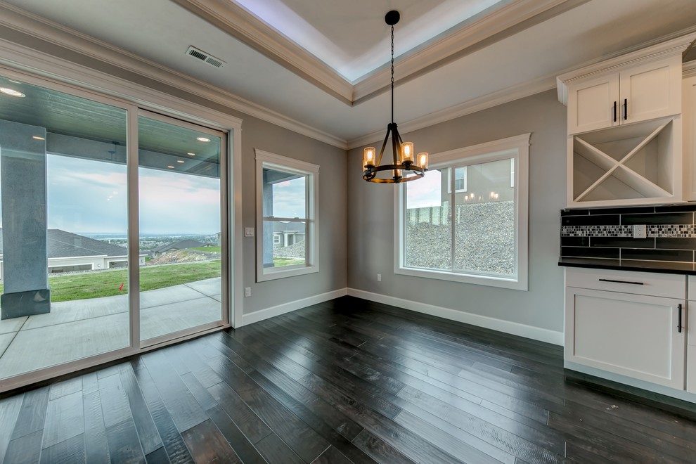 Small transitional medium tone wood floor great room photo in Seattle with gray walls, a standard fireplace and a stone fireplace