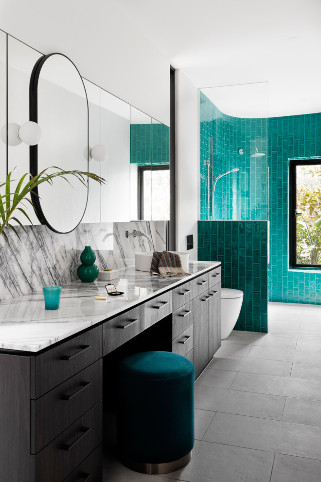 Small eclectic master wet room bathroom in Melbourne with flat-panel cabinets, black cabinets, a wall-mount toilet, green tile, porcelain tile, white walls, limestone floors, a vessel sink, marble benchtops, grey floor, an open shower and multi-coloured benchtops.