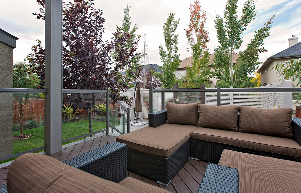Design ideas for a large transitional backyard deck in Calgary with no cover.
