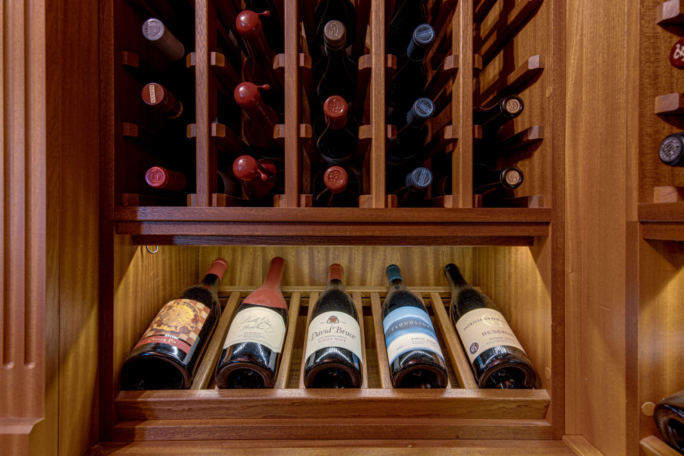 Secret passageway wine cellar. Basement layout with all mahogany racking.