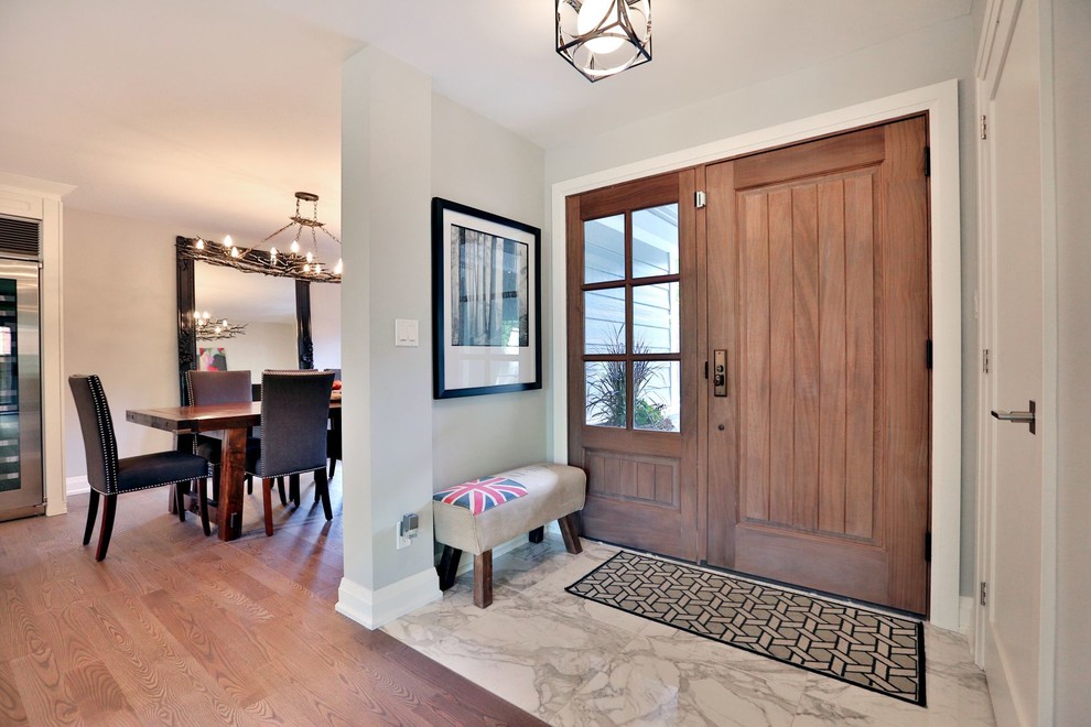 Example of a transitional gray floor single front door design with gray walls and a brown front door