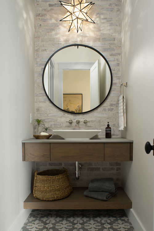 small bathroom with floating vanity and floor to ceiling tiled wall