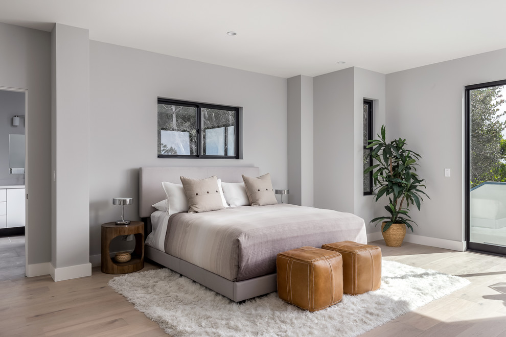 Large contemporary master bedroom in San Diego with grey walls, light hardwood floors, beige floor and no fireplace.